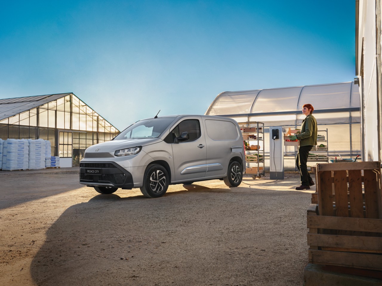 A Toyota Proace drives a long country road